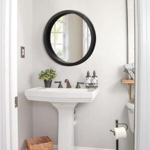 Small round wood-framed wall mirror