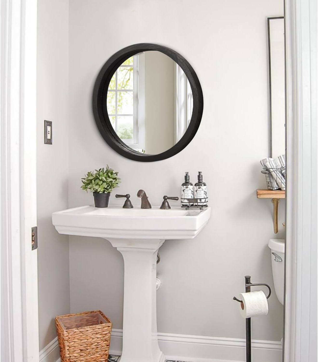Small round wood-framed wall mirror